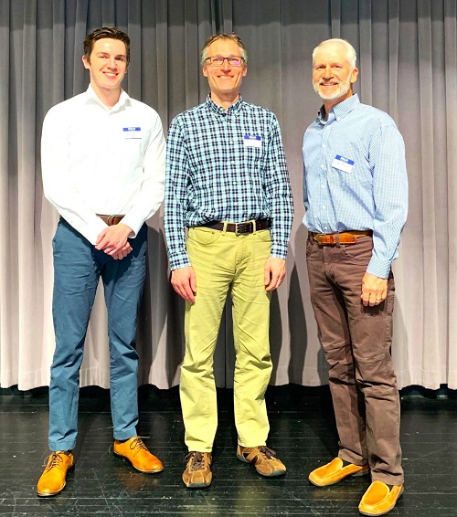 photo of three men at conference