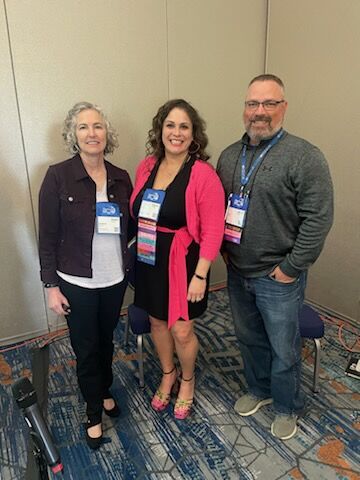 photo of three people at conference